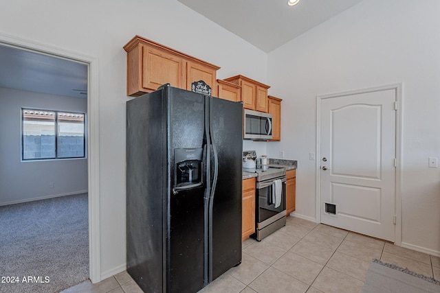 kitchen with light tile patterned floors and appliances with stainless steel finishes