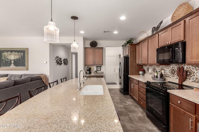805 E Ln Palta St, Queen Creek, AZ 85140 - kitchen featuring a sink, black appliances, visible vents, decorative backsplash, and hanging light fixtures