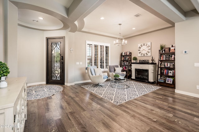 entrance foyer with dark hardwood / wood-style flooring and a notable chandelier