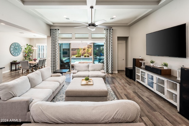 living room with wood-type flooring, beamed ceiling, coffered ceiling, and ceiling fan