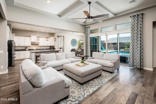 living room featuring coffered ceiling, beam ceiling, ceiling fan, dark hardwood / wood-style floors, and sink