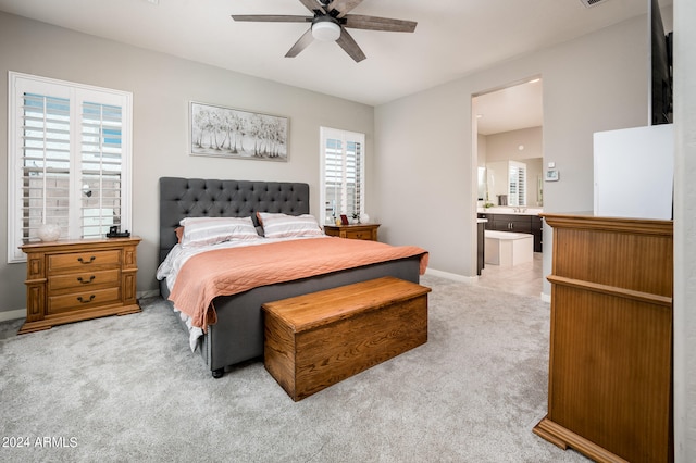 bedroom featuring connected bathroom, ceiling fan, and carpet floors