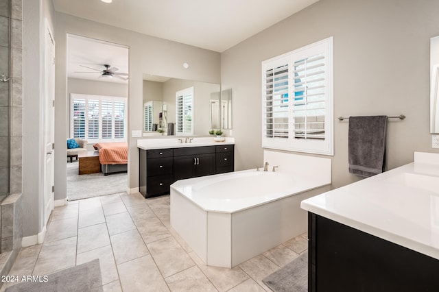 bathroom with tile patterned flooring, a bathing tub, vanity, and ceiling fan