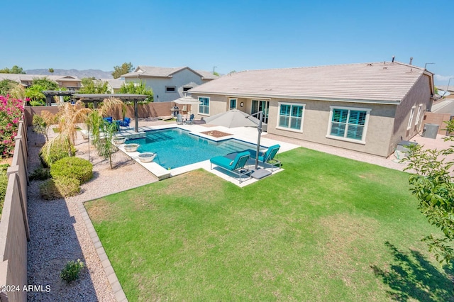 view of swimming pool with a yard and a patio area