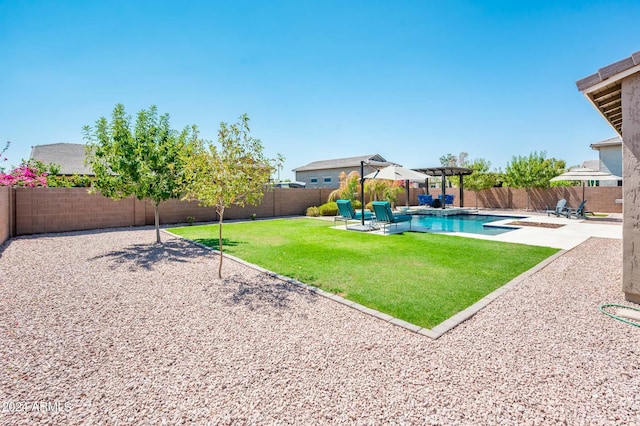 view of yard with a patio and a fenced in pool