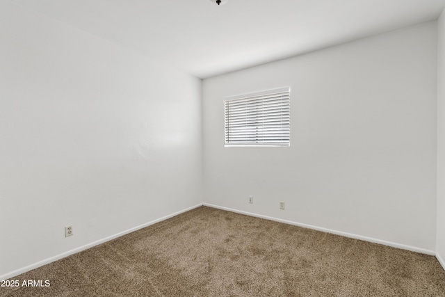 empty room with carpet floors and baseboards