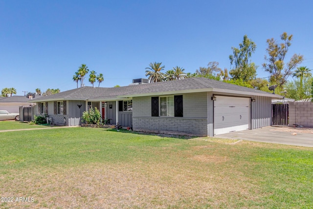 ranch-style home featuring a garage, brick siding, fence, concrete driveway, and a front yard