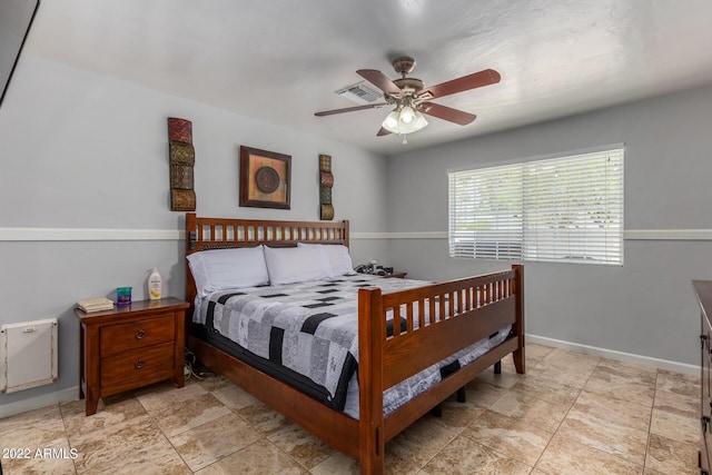 bedroom featuring ceiling fan, visible vents, and baseboards