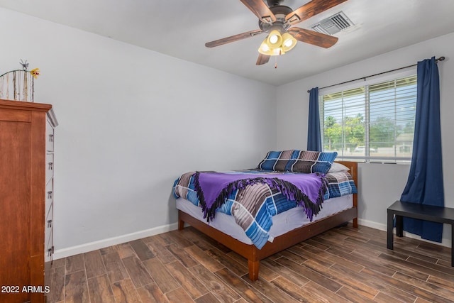 bedroom with baseboards, a ceiling fan, visible vents, and wood tiled floor