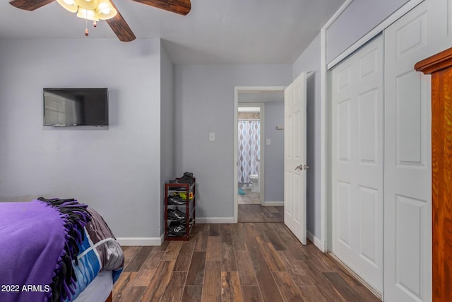 bedroom with dark wood-style floors, ceiling fan, baseboards, and a closet