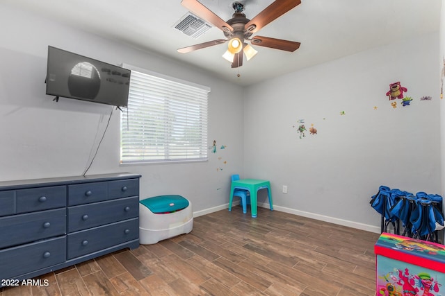 playroom featuring baseboards, visible vents, ceiling fan, and wood finished floors