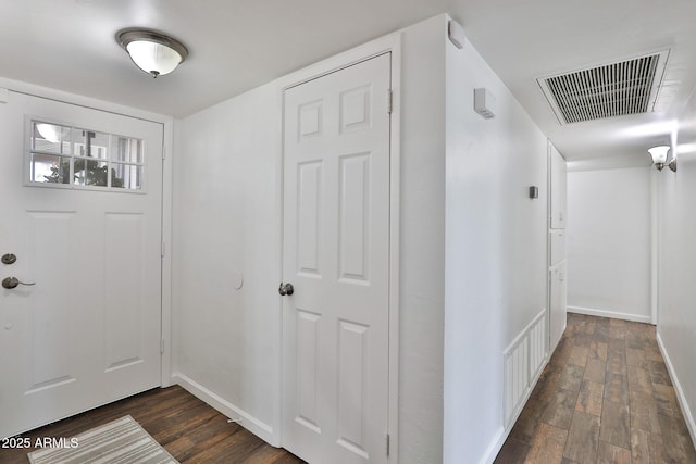 entrance foyer with dark wood-type flooring, visible vents, and baseboards