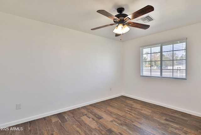 empty room with visible vents, dark wood finished floors, baseboards, and ceiling fan