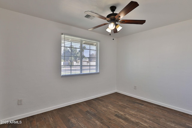 empty room with dark wood-style floors, baseboards, and a ceiling fan