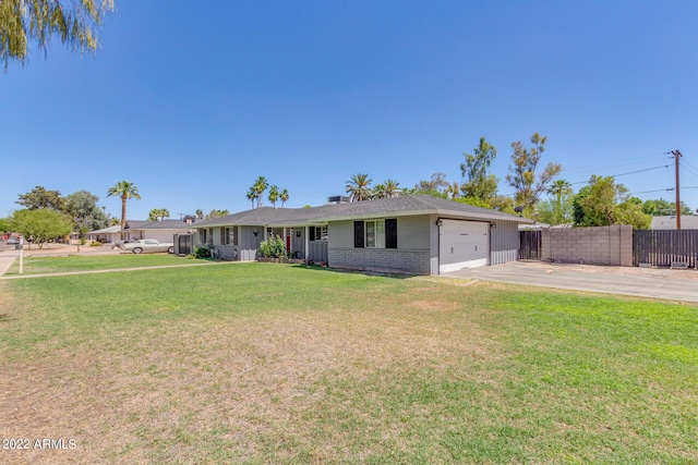 single story home featuring an attached garage, brick siding, fence, driveway, and a front lawn