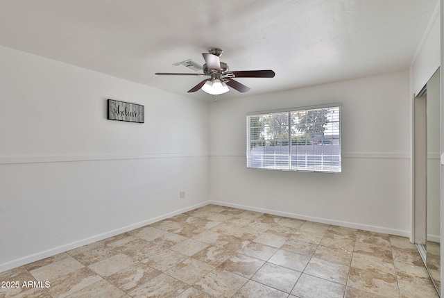 unfurnished room featuring a ceiling fan, visible vents, and baseboards