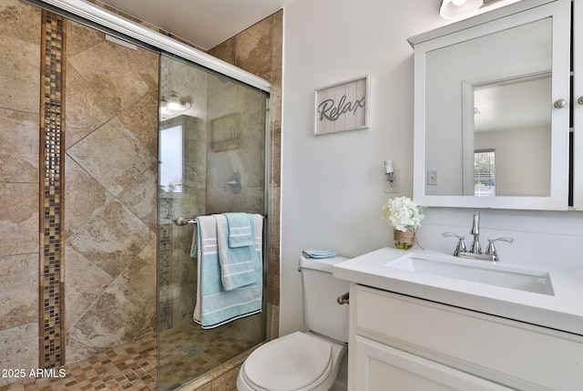 full bath featuring toilet, a tile shower, and vanity