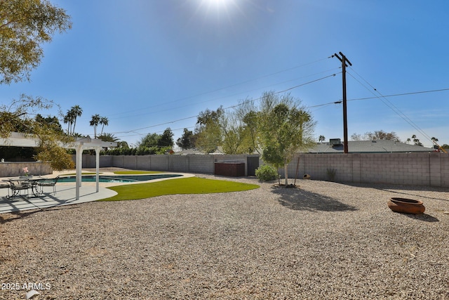 view of yard featuring a fenced backyard, a fenced in pool, and a patio