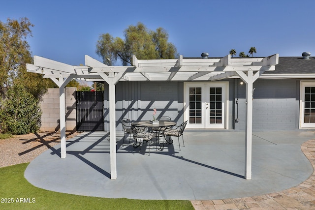 view of patio / terrace featuring fence and french doors