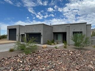 pueblo-style home with a garage