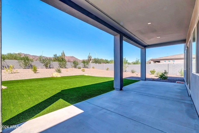 view of patio with a fenced backyard and a mountain view