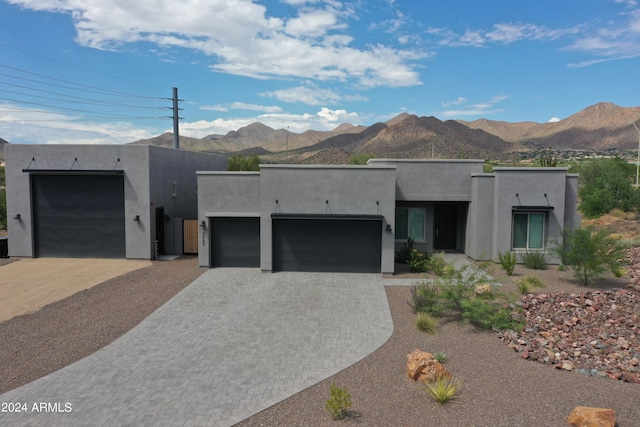 view of front of house featuring a garage and a mountain view