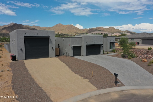 pueblo revival-style home featuring a mountain view and a garage