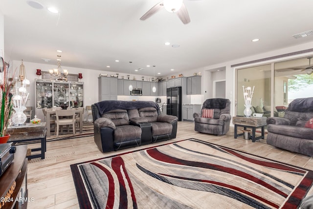 living room with ceiling fan and light hardwood / wood-style floors