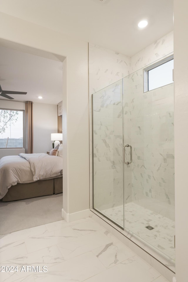 bathroom with a shower with shower door, a healthy amount of sunlight, and ceiling fan