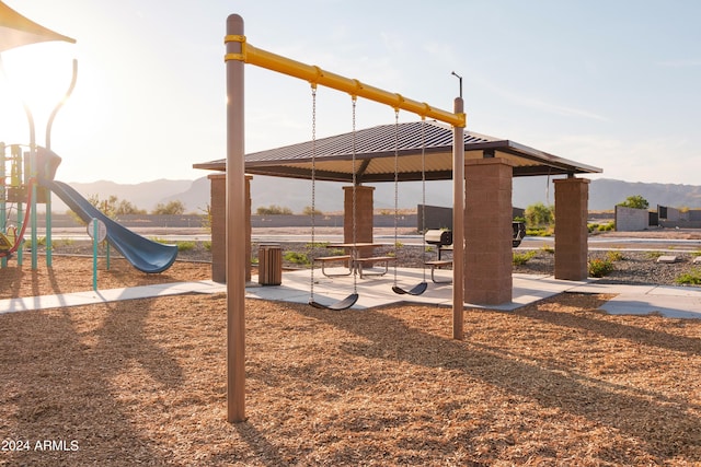 view of jungle gym with a gazebo and a mountain view