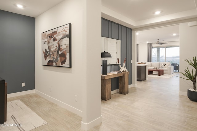 corridor with light hardwood / wood-style floors