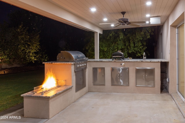 view of patio / terrace with ceiling fan, grilling area, an outdoor kitchen, and sink