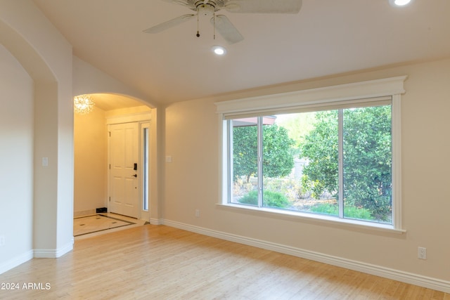 empty room with light wood-type flooring, a wealth of natural light, and ceiling fan