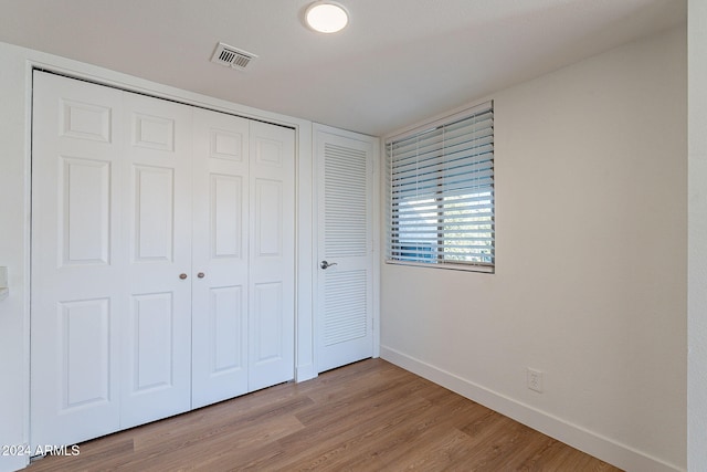 unfurnished bedroom with light wood-type flooring