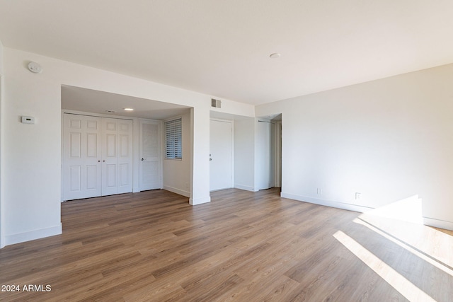 unfurnished bedroom with hardwood / wood-style flooring