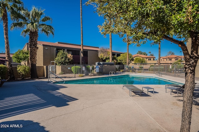 view of swimming pool with a patio