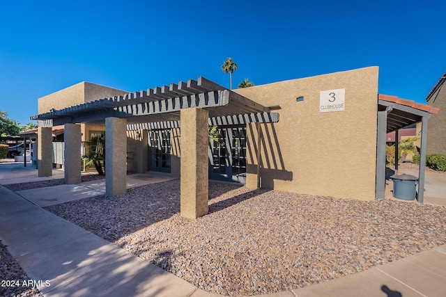 view of side of property featuring a pergola