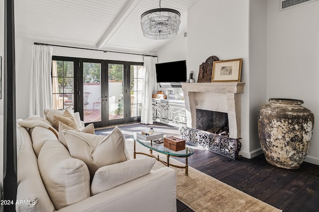 living room with a high end fireplace, french doors, wood-type flooring, an inviting chandelier, and beamed ceiling