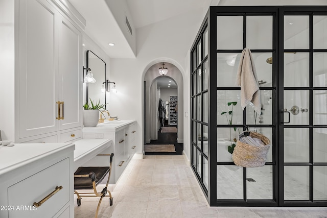 bathroom featuring tile patterned flooring, a shower, and vanity