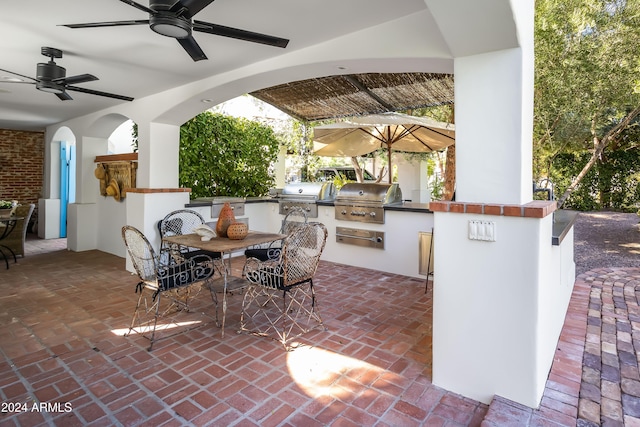 view of patio / terrace with a grill, ceiling fan, and exterior kitchen