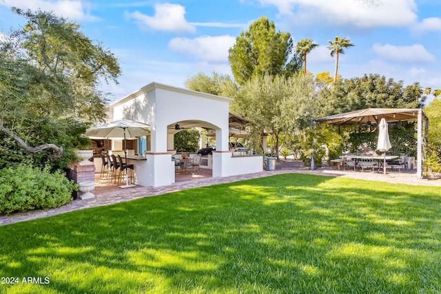 view of yard featuring a patio area and an outdoor bar