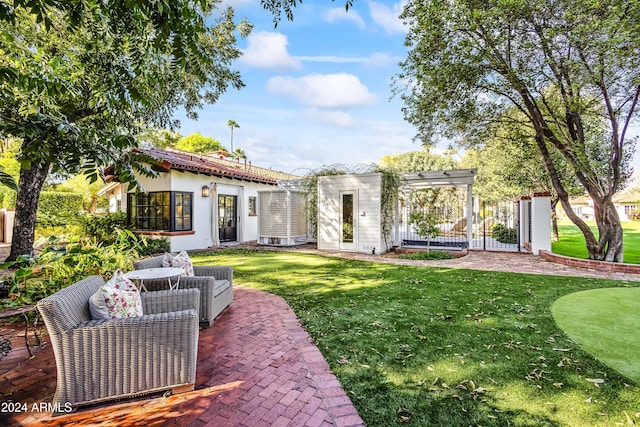 back of property with a lawn and a patio