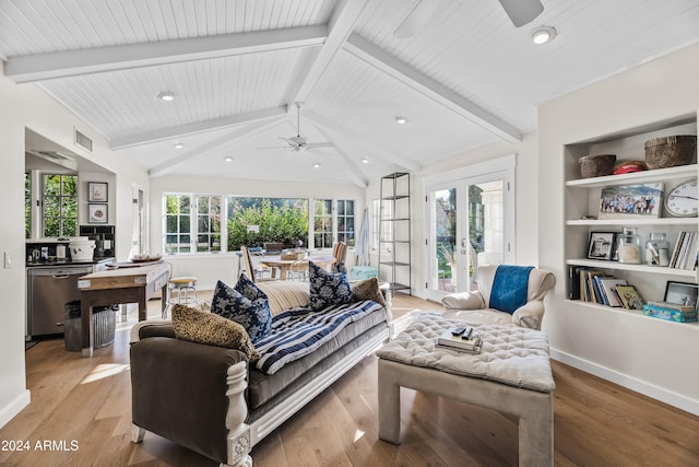 living room with vaulted ceiling with beams, plenty of natural light, light hardwood / wood-style floors, and french doors