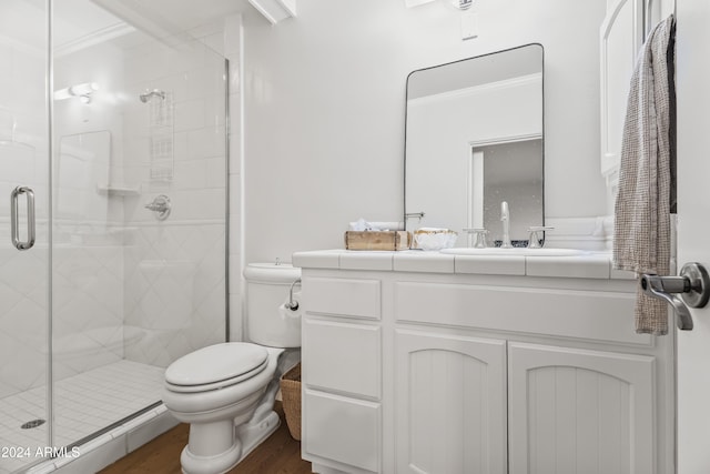 bathroom with an enclosed shower, ornamental molding, vanity, hardwood / wood-style floors, and toilet