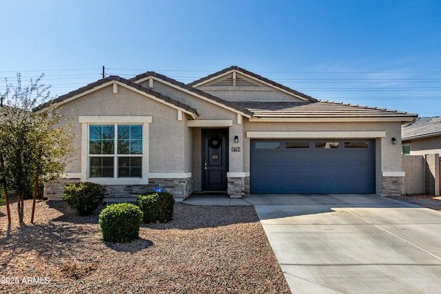 view of front of property featuring concrete driveway, an attached garage, stone siding, and stucco siding