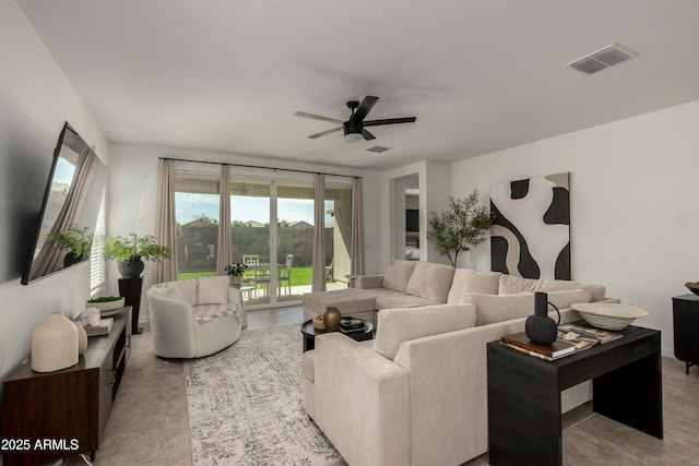 living area featuring visible vents and ceiling fan