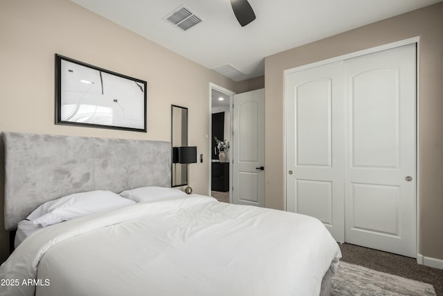 carpeted bedroom with visible vents, a closet, and ceiling fan