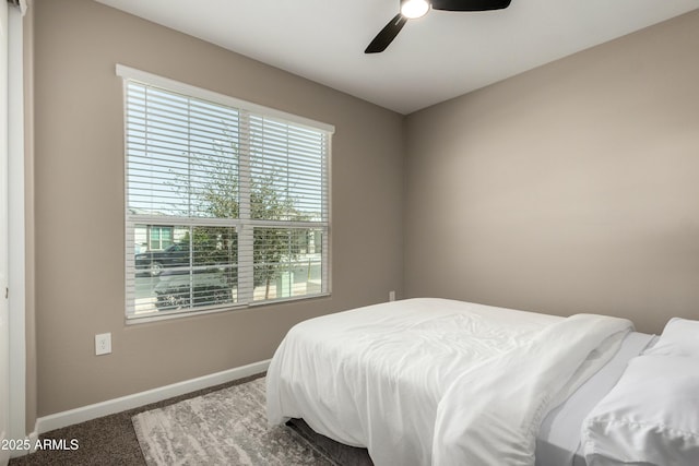 carpeted bedroom with a ceiling fan and baseboards