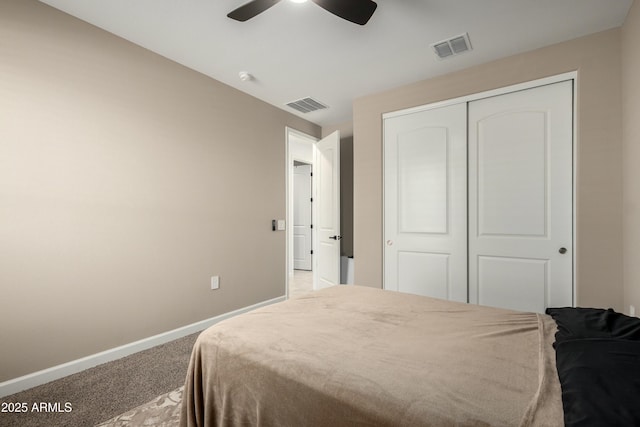 carpeted bedroom with a closet, visible vents, ceiling fan, and baseboards