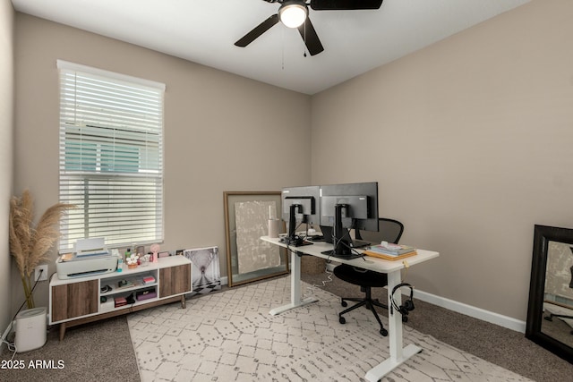 home office featuring baseboards, carpet, and a ceiling fan